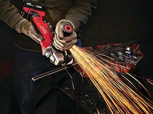 Person using an angle grinder with sparks flying.