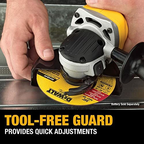 Person adjusting angle grinder with tool-free guard.