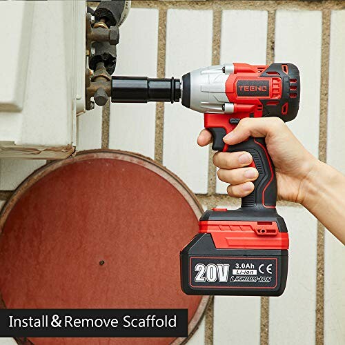 Person using a red cordless impact wrench on a scaffold