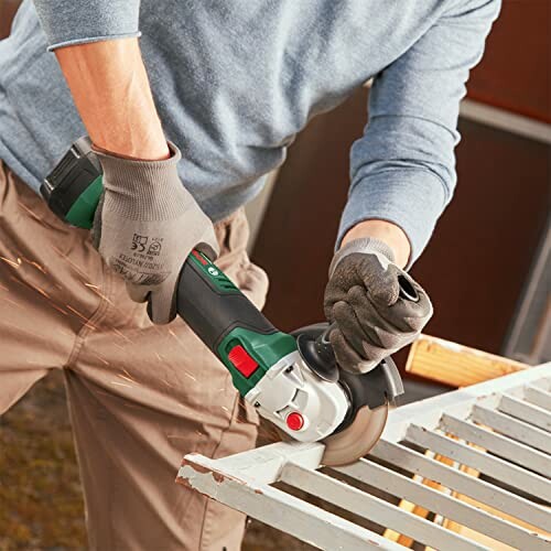 Person using an angle grinder on metal