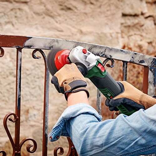 Person using an angle grinder on a metal surface.