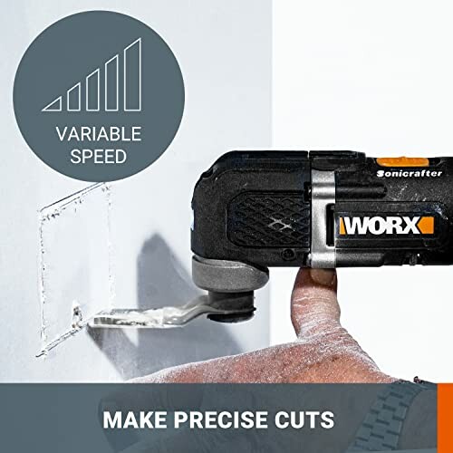 Hand using a WORX Sonicrafter tool to cut a square in a wall with variable speed feature.